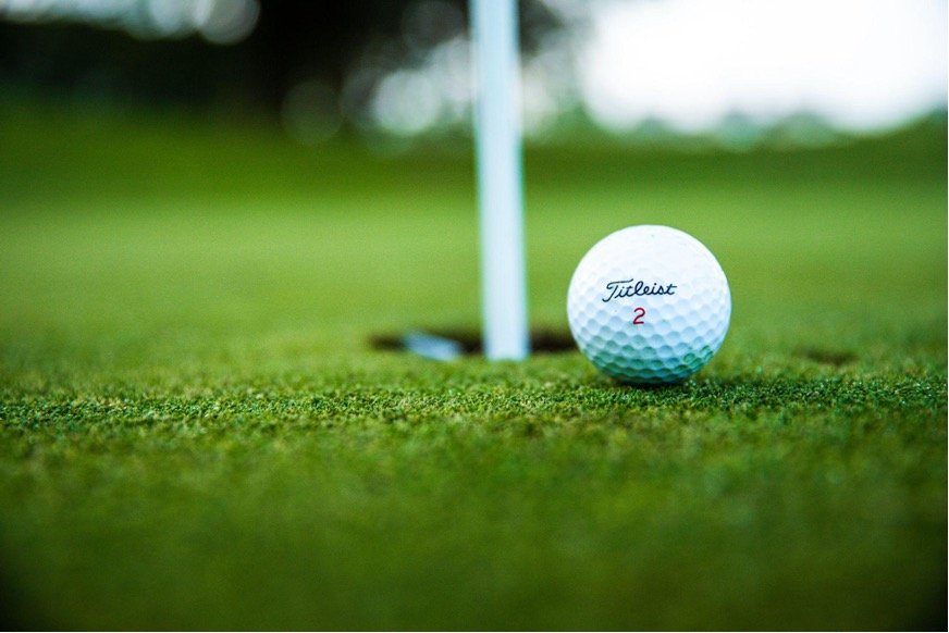 A golf ball near a hole